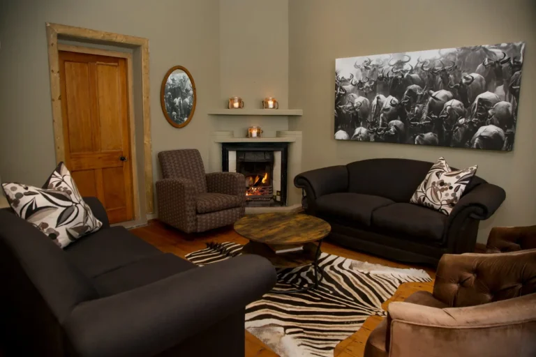 Lodge-Wohnzimmer mit Kamin, Ledersofas und Zebrafell