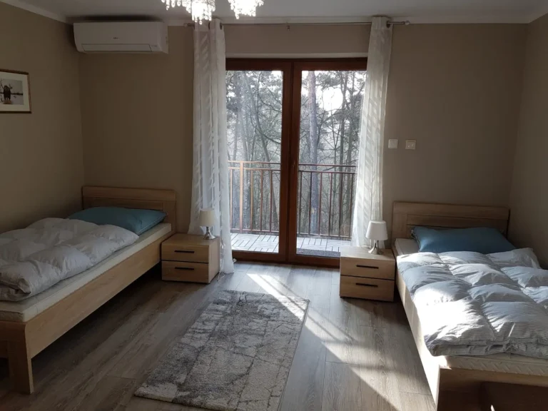 Zweibettzimmer mit Balkontür zum Wald